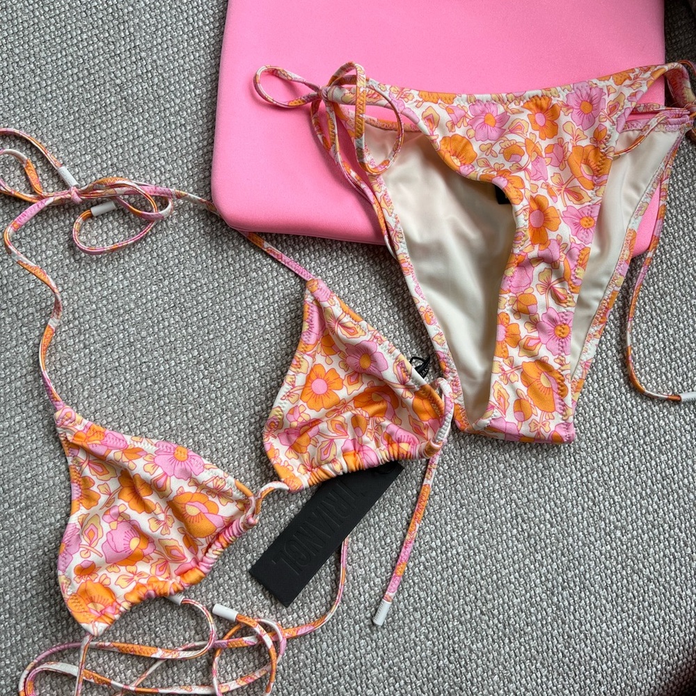Brand new Triangl bathing suit with tags. Size small top medium bottoms.With bag